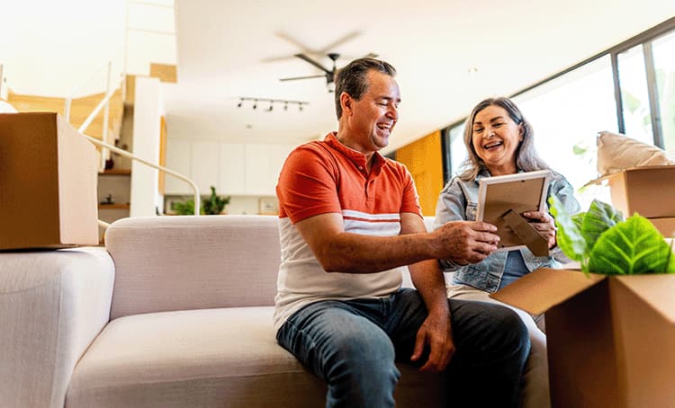 Male and Female Older Adult reviewing photos to Downsize to move to senior living this year